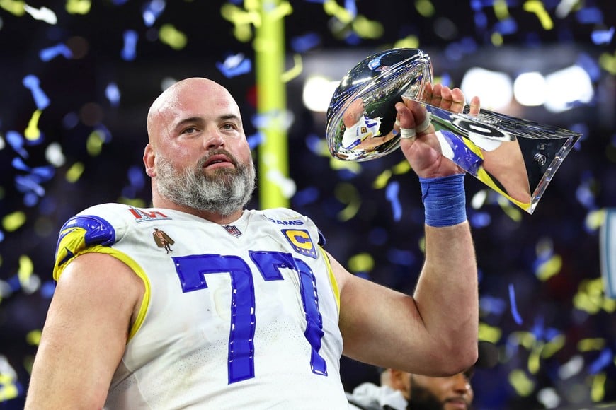 Feb 13, 2022; Inglewood, CA, USA; Los Angeles Rams offensive tackle Andrew Whitworth (77) hoists the Lombardi Trophy after defeating the Cincinnati Bengals in Super Bowl LVI at SoFi Stadium. Mandatory Credit: Mark J. Rebilas-USA TODAY Sports