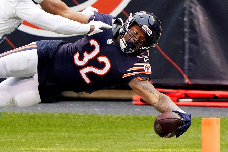 Dec 6, 2020; Chicago, Illinois, USA; Chicago Bears running back David Montgomery (32) dives for a touchdown against Detroit Lions strong safety Duron Harmon (26) during the first quarter at Soldier Field. Mandatory Credit: Mike Dinovo-USA TODAY Sports     TPX IMAGES OF THE DAY