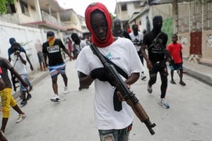 Former police officer Jimmy "Barbecue" Cherizier (not pictured), leader of the 'G9' coalition, is accompanied by Security during a march against Haiti's Prime Minister Ariel Henry, in Port-au-Prince, Haiti September 19, 2023. REUTERS/Ralph Tedy Erol