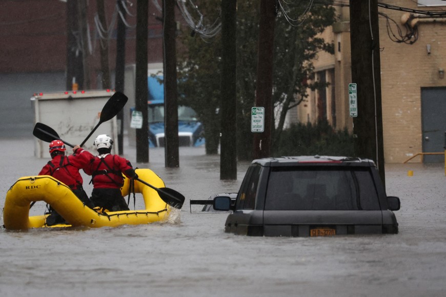 Special Operations Unit rescue personnel with the Westchester County  Emergency Services paddle in rafts as they check buildings for victims trapped in heavy flooding in the New York City suburb of Mamaroneck, New York, U.S., September 29, 2023. REUTERS/Mike Segar