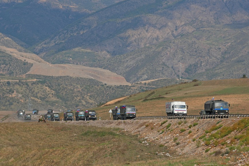 FILE PHOTO: Vehicles of Russian peacekeepers leaving Azerbaijan's Nagorno-Karabakh region for Armenia pass an Armenian checkpoint on a road near the village of Kornidzor, Armenia September 22, 2023. REUTERS/Irakli Gedenidze/File Photo