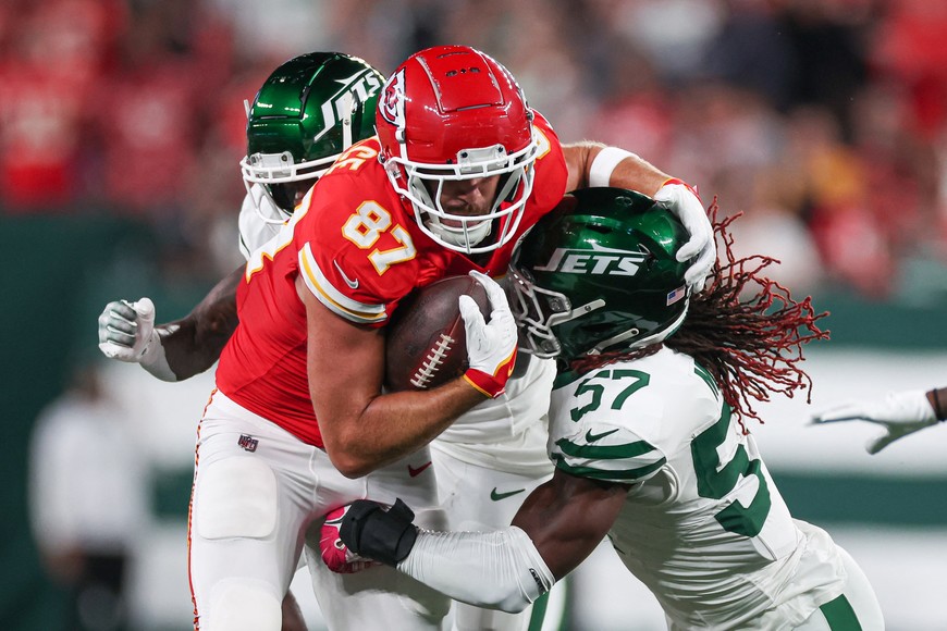 Oct 1, 2023; East Rutherford, New Jersey, USA; Kansas City Chiefs tight end Travis Kelce (87) is tackled by New York Jets linebacker C.J. Mosley (57) during the first quarter at MetLife Stadium. Mandatory Credit: Vincent Carchietta-USA TODAY Sports