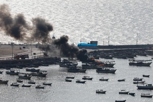 Smoke billows from a boat following Israeli strikes, at Port of Gaza, October 8, 2023. REUTERS/Mohammed Salem     TPX IMAGES OF THE DAY