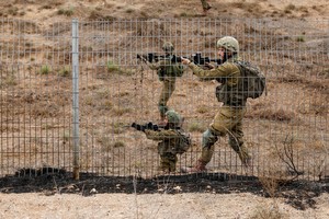 Israeli soldiers scan an area while sirens sound as rockets from Gaza are launched towards Israel,, near Sderot, southern Israel, October 9, 2023. REUTERS/Amir Cohen