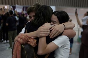 A woman, who was repatriated from Israel, embraces her relatives after arriving at Rio de Janeiro’s international airport, Brazil October 11, 2023. REUTERS/Pilar Olivares