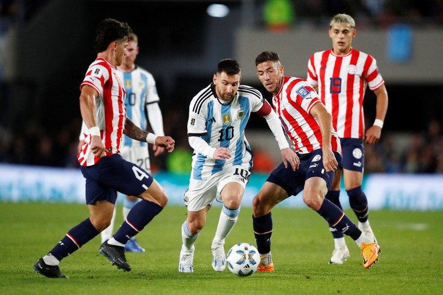 Soccer Football - World Cup - South American Qualifiers - Argentina v Paraguay - Estadio Mas Monumental, Buenos Aires, Argentina - October 12, 2023
Argentina's Lionel Messi  in action with Paraguay's Alvaro Campuzano REUTERS/Agustin Marcarian