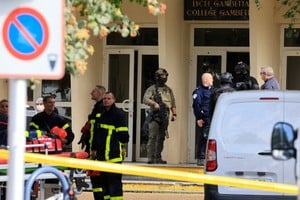 French police, soldiers and fire fighters work at the site after a teacher was killed and several people injured in a knife attack at the Lycee Gambetta-Carnot high school in Arras, northern France, October 13, 2023. REUTERS/Pascal Rossignol