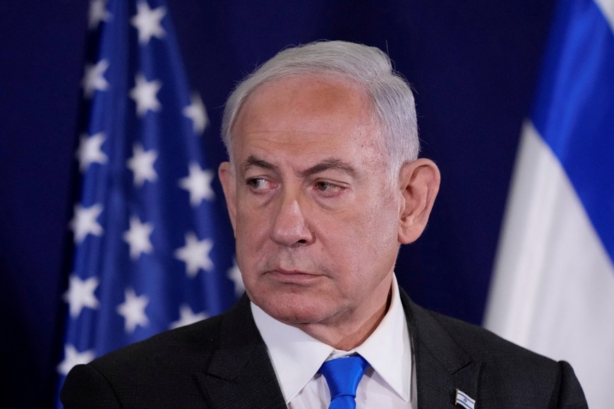 Israel’s Prime Minister Benjamin Netanyahu listens as U.S. Secretary of State Antony Blinken makes a statement to the media inside The Kirya, which houses the Israeli Ministry of Defense, after their meeting, in Tel Aviv, Israel, Thursday Oct. 12, 2023. Jacquelyn Martin/Pool via REUTERS