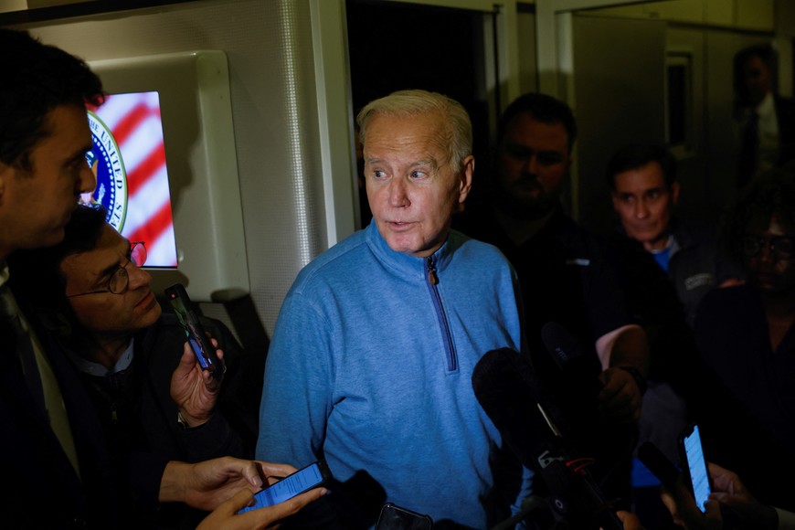 U.S. President Joe Biden speaks to the press onboard of Air Force One en route from Israel, amid the ongoing conflict between Israel and Hamas, at Ramstein Air Base, Germany, October 18, 2023. REUTERS/Evelyn Hockstein