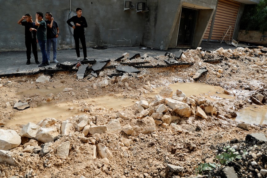 Palestinians stand on the destroyed Shireen Abu Akleh street, following an Israeli raid, in Jenin Camp, in the Israeli-occupied West Bank October 27, 2023. REUTERS/Raneen Sawafta