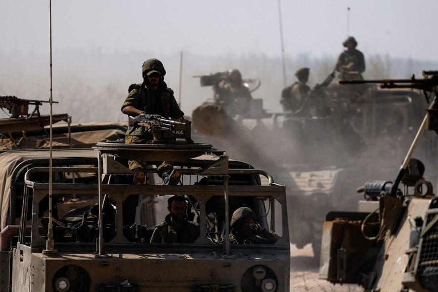 Israeli soldiers ride a military vehicle near the Israeli side of the border between Israel and the Gaza Strip, November 3, 2023. REUTERS/Amir Cohen
