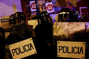 Riot police stand guard next to stickers that read 'no to amnesty', as people protest near Spain's Socialists Party (PSOE) headquarters, after Spain's socialists reached a deal with the Catalan separatist Junts party for government support, a pact which involves amnesties for people involved with Catalonia's failed 2017 independence bid, in Madrid, Spain November 12, 2023. REUTERS/Susana Vera