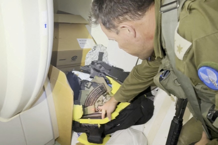 An Israeli officer points at what he describes as a grab bag containing a rifle and other munitions belonging to a Hamas fighter that was discovered behind an MRI machine at the Al Shifa hospital complex, amid the Israeli military's ground operation against Palestinian Islamist group Hamas, in Gaza City, November 15, 2023 in this still image taken from video. Israeli forces said the "beating heart" of the Hamas fighters' operations was headquartered in tunnels beneath the hospital. Hamas denied the accusation and on Wednesday dismissed the Israeli statements as "lies and cheap propaganda."   Israeli Army/Handout via REUTERS    THIS IMAGE HAS BEEN SUPPLIED BY A THIRD PARTY.