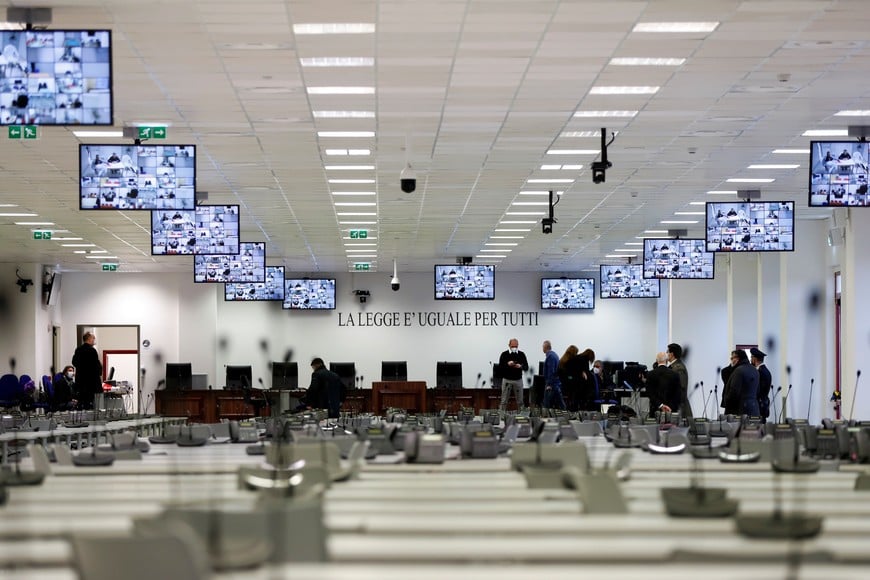 Some of the defendants in a trial against 355 suspected members of the 'Ndrangheta mafia, accused of an array of charges, are seen on screens as they join via video link on the first day of their trial, in a High Security Courthouse in Lamezia Terme, Italy, January 13, 2021. REUTERS/Yara Nardi