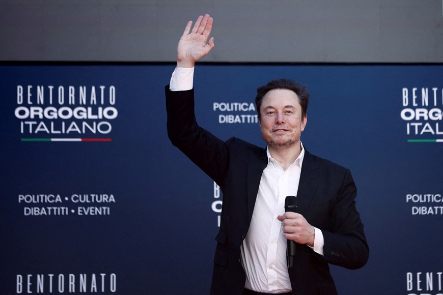 FILE PHOTO: Tesla and SpaceX's CEO Elon Musk gestures, as he attends political festival Atreju organised by Italian Prime Minister Giorgia Meloni's Brothers of Italy (Fratelli d'Italia) right-wing party, in Rome, Italy, December 16, 2023. REUTERS/Guglielmo Mangiapane/File Photo