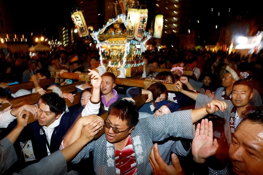 People  carry an illuminated "Mikoshi" or portable shrine during a countdown event to celebrating the new year in Yokosuka, south of Tokyo, January 1, 2024.  REUTERS/Kim Kyung-Hoon