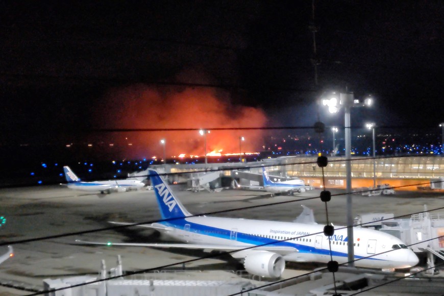 An airplane is on fire at Haneda International Airport, in Tokyo, Japan January 2, 2024, in this screen grab obtained from social media video. X/@hanenoumi_kudou/via REUTERS  THIS IMAGE HAS BEEN SUPPLIED BY A THIRD PARTY. MANDATORY CREDIT.