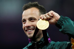 FILE PHOTO: South Africa's Oscar Pistorius celebrates with his gold medal after winning the men's 400m T44 classification at the Olympic Stadium during the London 2012 Paralympic Games September 8, 2012. REUTERS/Eddie Keogh/File Photo