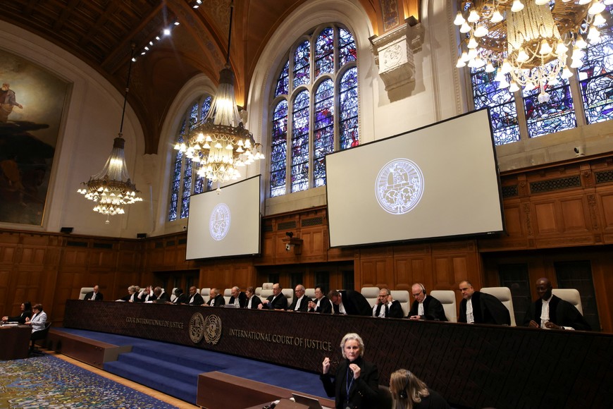 People sit inside the International Court of Justice (ICJ) as judges hear a request for emergency measures to order Israel to stop its military actions in Gaza, in The Hague, Netherlands January 12, 2024. REUTERS/Thilo Schmuelgen