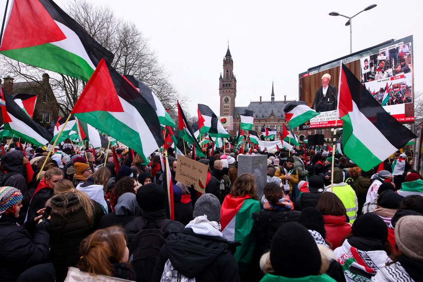 Pro-Palestinian protesters watch the proceedings on a screen near the International Court of Justice (ICJ) as judges hear a request for emergency measures by South Africa to order Israel to stop its military actions in Gaza, in The Hague, Netherlands January 12, 2024. REUTERS/Thilo Schmuelgen