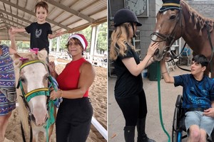 Alumnos practicando equinoterapia con sus terapeutas.