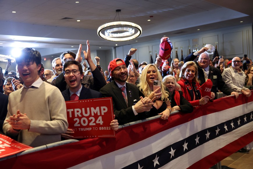 Supporters of Republican presidential candidate and former U.S. President Donald Trump react as results are announced by major news organisations during his New Hampshire presidential primary election night watch party in Nashua, New Hampshire, U.S. January 23, 2024. REUTERS/Mike Segar