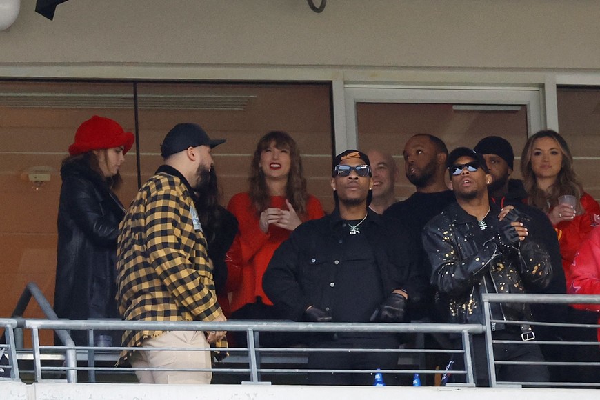 Jan 28, 2024; Baltimore, Maryland, USA; American singer-songwriter Taylor Swift (center) looks on from the stands during the second half in the AFC Championship football game between the Kansas City Chiefs and the Baltimore Ravens at M&T Bank Stadium. Mandatory Credit: Geoff Burke-USA TODAY Sports