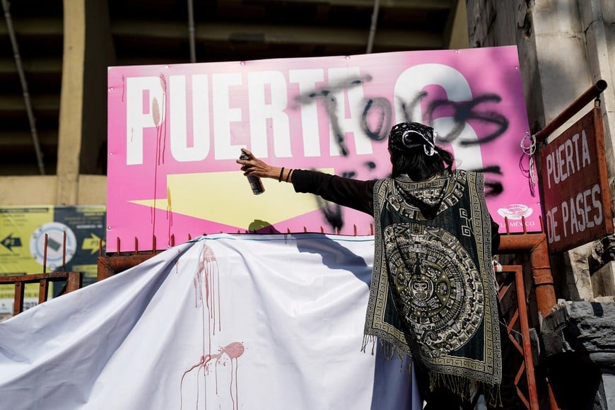 A demonstrator makes graffiti during a protest against the return of bullfighting, outside the Plaza de Toros Mexico bullfighting ring, in Mexico City, Mexico, January 28, 2024. REUTERS/Toya Sarno Jordan