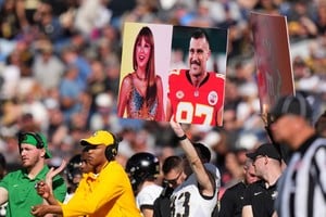 FILE PHOTO: Nov 4, 2023; Denver, Colorado, USA; Army Black Knights members hold up a call in play sign of American recording artist Taylor Swift and American football player Travis Kelce in the first half against the Air Force Falcons at Empower Field at Mile High. Mandatory Credit: Ron Chenoy-USA TODAY Sports/File Photo