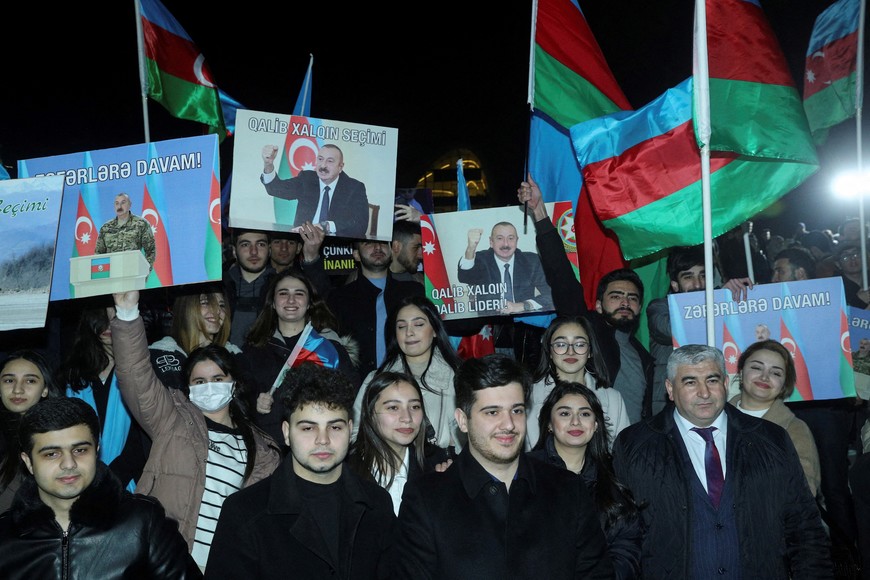 FILE PHOTO: Supporters of Ilham Aliyev, Azerbaijan's incumbent President and a candidate for the Azeri presidential elections, celebrate in a street following the announcement of exit poll results in Baku, Azerbaijan, February 7, 2024. REUTERS/Aziz Karimov/File Photo