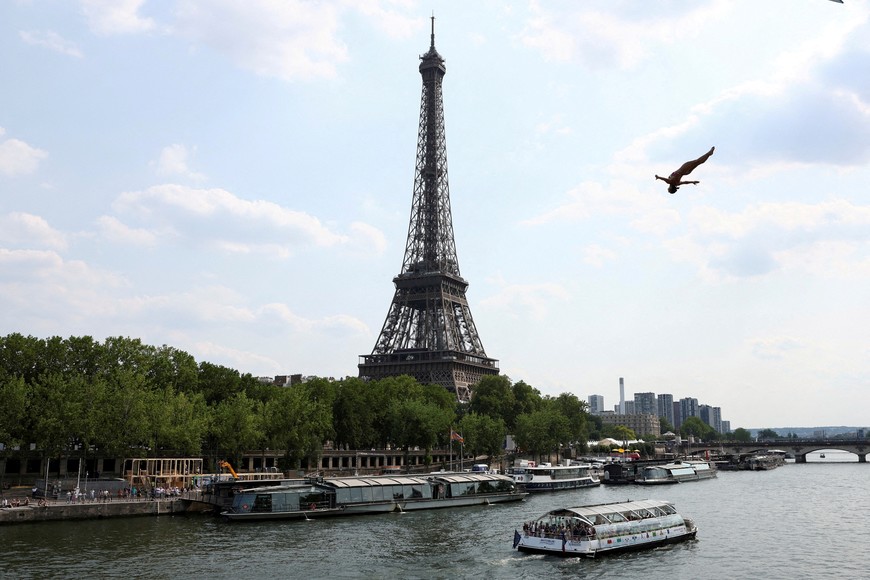 FILE PHOTO: An athlete dives off the Port Debilly on the banks of the Seine river in front of the Eiffel tower during a training ahead of the competition Red Bull Cliff Diving World in Paris, France, June 16, 2023. REUTERS/Stephanie Lecocq/File Photo