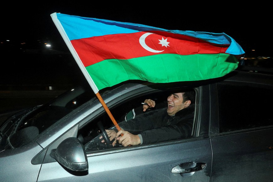 FILE PHOTO: A participant of a motor rally reacts inside a car following the announcement of exit poll results of the presidential elections in Baku, Azerbaijan, February 7, 2024. REUTERS/Aziz Karimov/File Photo