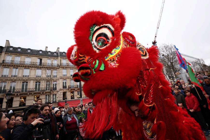 (240205) -- PARIS, 5 febrero, 2024 (Xinhua) -- Imagen del 4 de febrero de 2024 de personas observando la tradicional danza del león para celebrar el próximo Año Nuevo Lunar chino, en la Avenida de los Campos Elíseos, en París, Francia. (Xinhua/Gao Jing) (rtg) (ah) (vf)