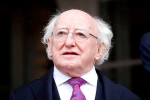 FILE PHOTO: Irish President Michael Higgins looks on during his state visit to Austria prior to his business meeting with Austrian President Alexander Van der Bellen in Vienna, Austria, April 6, 2022. REUTERS/Lisa Leutner/File Photo