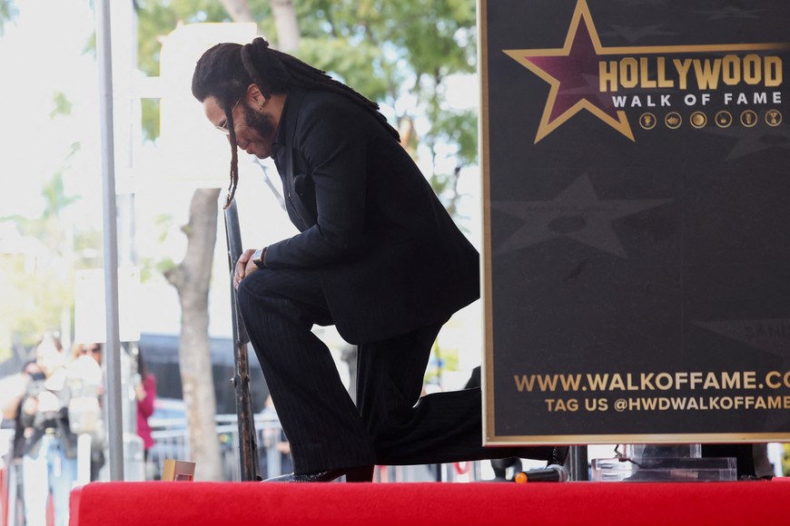 Lenny Kravitz kneels during the unveiling ceremony of his star on the Hollywood Walk of Fame, in Los Angeles, California, U.S. March 12, 2024. REUTERS/Mario Anzuoni