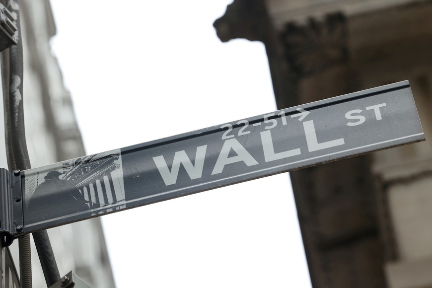 FILE PHOTO: A street sign marks Wall Street outside the New York Stock Exchange (NYSE) in New York City, where markets roiled after Russia continues to attack Ukraine, in New York, U.S., February 24, 2022.   REUTERS/Caitlin Ochs/File Photo