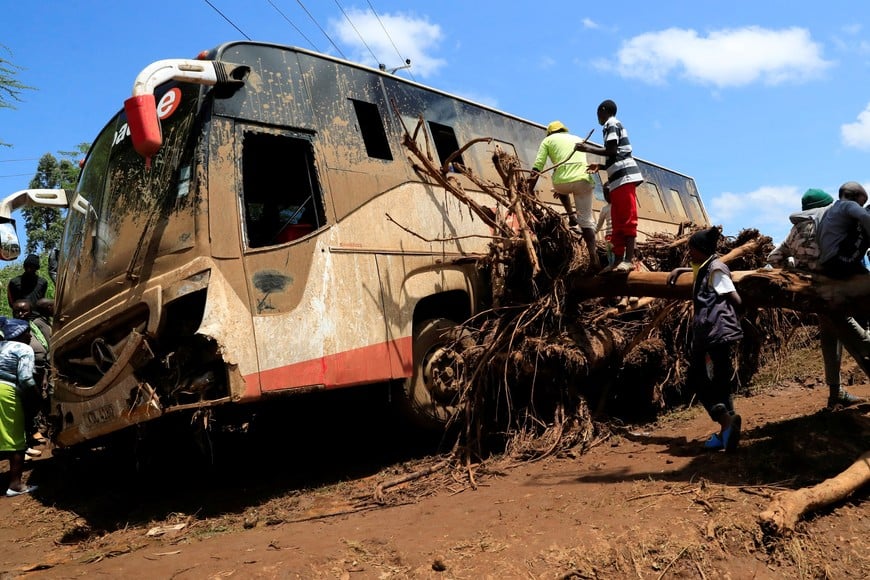 A view shows a damaged passenger bus stuck on a fallen tree after heavy flash floods wiped out several homes when a dam burst, following heavy rains in Kamuchiri village of Mai Mahiu, Nakuru County, Kenya April 29, 2024. REUTERS/Thomas Mukoya