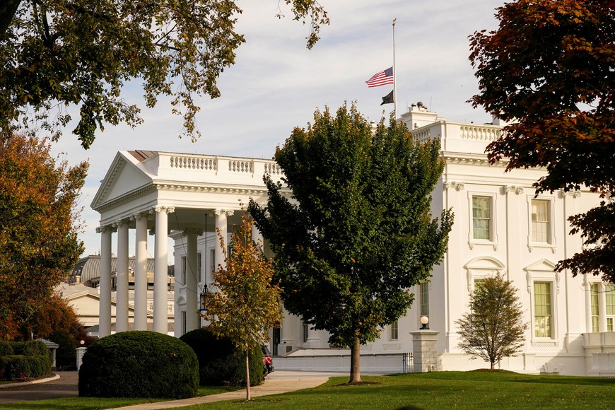 The U.S. flag flies at half-staff atop the White House in recognition of the victims in Lewiston, Maine, after a deadly shooting, in Washington, U.S., October 26, 2023. REUTERS/Ken Cedeno