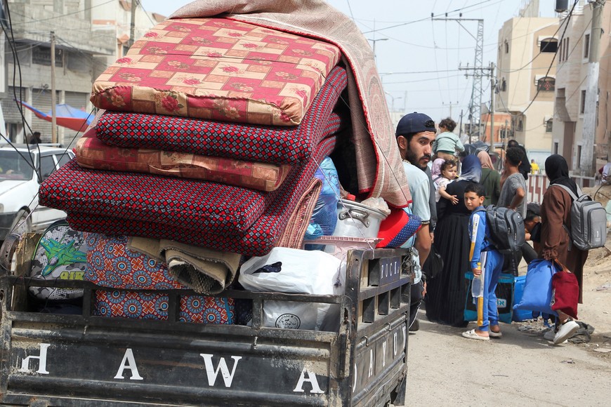 A man looks from a vehicle loaded with belongings, as Palestinians prepare to evacuate, after Israeli forces launched a ground and air operation in the eastern part of Rafah, amid the ongoing conflict between Israel and Hamas, in Rafah, in the southern Gaza Strip, May 11, 2024. REUTERS/Hatem Khaled