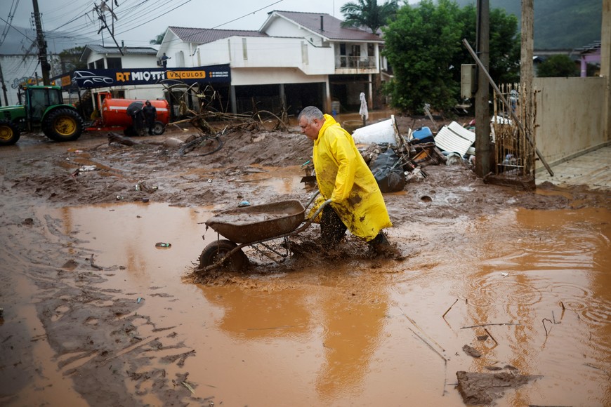 A man helps cleaning a house partially destroyed after floods in Mucum, Rio Grande do Sul state, Brazil May 11, 2024. REUTERS/Adriano Machado