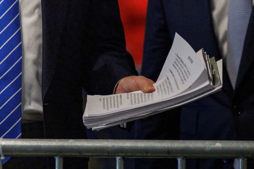 Former US President Donald Trump holds a paper with quotes as he speaks to the press with his lawyer Todd Blanche after attending his criminal trial for the day at New York State Supreme Court in New York, New York, USA, 13 May 2024. Trump is facing 34 felony counts of falsifying business records related to payments made to adult film star Stormy Daniels during his 2016 presidential campaign.    SARAH YENESEL/Pool via REUTERS