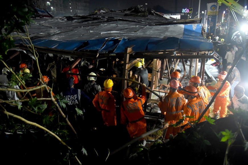 Members of rescue teams search for survivors amidst the debris after a massive billboard fell during a rainstorm in Mumbai, India, May 13, 2024. REUTERS/Stringer