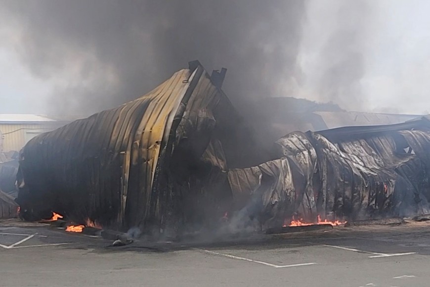 Smoke rises from a damaged garage as rioters protest against plans to allow more people to take part in local elections in the French-ruled territory, which indigenous Kanak protesters reject, in Noumea, New Caledonia, May 15, 2024, in this picture obtained from social media. Yoan Fleurot/via REUTERS  THIS IMAGE HAS BEEN SUPPLIED BY A THIRD PARTY. MANDATORY CREDIT. NO RESALES. NO ARCHIVES.