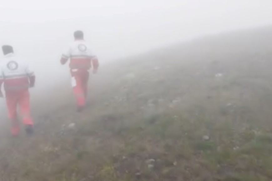 Emergency personnel walk in a foggy area following a crash of a helicopter carrying Iran's President Ebrahim Raisi, in Varzaqan , East Azerbaijan Province, Iran, May 19, 2024 in this screen grab from a video. Iranian Red Crescent Society/Handout via REUTERS    THIS IMAGE HAS BEEN SUPPLIED BY A THIRD PARTY. NO RESALES. NO ARCHIVES. MANDATORY CREDIT