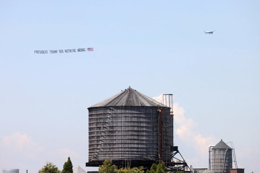 A supporter of former U.S. President Donald Trump flies in a plane with a banner along the Hudson River, as Trump's trial for allegedly covering up hush money payments linked to porn star Stormy Daniels before the 2016 presidential election continues, in Manhattan, New York City, U.S., May 21, 2024. REUTERS/Andrew Kelly     TPX IMAGES OF THE DAY