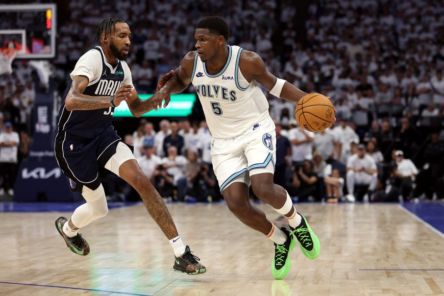 May 22, 2024; Minneapolis, Minnesota, USA; Minnesota Timberwolves guard Anthony Edwards (5) controls the ball against Dallas Mavericks forward Derrick Jones Jr. (55) in the fourth quarter during game one of the western conference finals for the 2024 NBA playoffs at Target Center. Mandatory Credit: Jesse Johnson-USA TODAY Sports