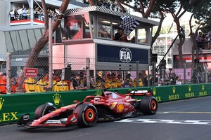 Formula One F1 - Monaco Grand Prix - Circuit de Monaco, Monaco - May 26, 2024
Ferrari's Charles Leclerc passes the chequered flag which is waved by Kylian Mbappe to win the Monaco Grand Prix REUTERS/Jennifer Lorenzini