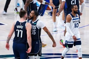 May 26, 2024; Dallas, Texas, USA; Dallas Mavericks guard Luka Doncic (77) ceelbrates with Dallas Mavericks forward Derrick Jones Jr. (55) in fron tof Minnesota Timberwolves guard Mike Conley (10) after the game during game three of the western conference finals for the 2024 NBA playoffs at American Airlines Center. Mandatory Credit: Kevin Jairaj-USA TODAY Sports