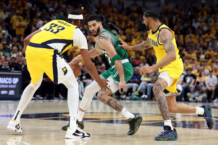 May 25, 2024; Indianapolis, Indiana, USA; Boston Celtics forward Jayson Tatum (middle) controls the ball against Indiana Pacers center Myles Turner (33) and forward Obi Toppin (right) during the fourth quarter of game three of the eastern conference finals in the 2024 NBA playoffs at Gainbridge Fieldhouse. Mandatory Credit: Trevor Ruszkowski-USA TODAY Sports