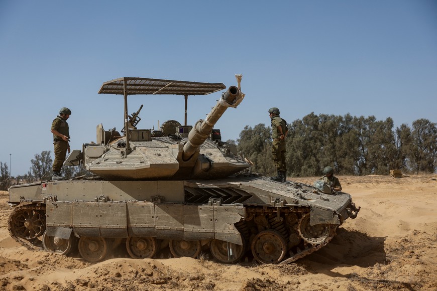 Israeli soldiers stand on a tank, amid the ongoing conflict between Israel and the Palestinian Islamist group Hamas, near the Israel-Gaza border, in southern Israel, May 5, 2024. REUTERS/Amir Cohen